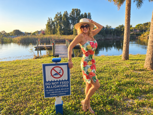 Soledad Music Official by a Florida lake at sunset, next to a Do Not Feed Alligators sign